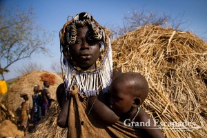 The most distinctive of all ethnic groups in the Omo Valley: the Mursi, famous for the huge Lip Plates the women are sporting. Mago National Park, near Jinka, Lower Omo Valley, South Ethiopia