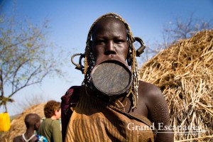 The most distinctive of all ethnic groups in the Omo Valley: the Mursi, famous for the huge Lip Plates the women are sporting. Mago National Park, near Jinka, Lower Omo Valley, South Ethiopia