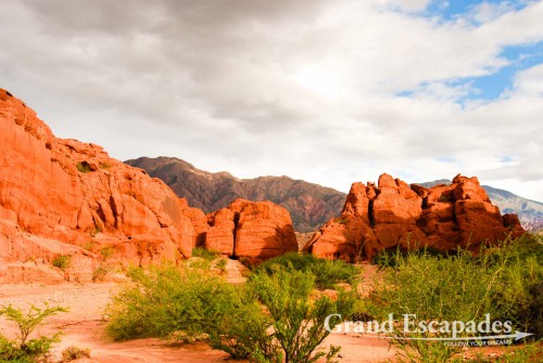 La Quebrada de Cafayate - A magic display of colours, dark red or pinkish hills and whitish cliffs with brown tops are often twisted into bizarre formations