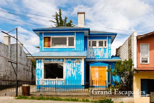 Punta Arenas, Patagonia, Chile - The more common sight here are houses made of wood with thin sheets of metals nailed onto them, then the building is painted in the wildest colour
