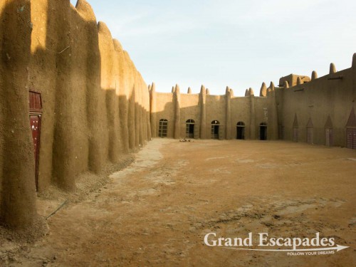 Inside the biggest mud building in the world: the Mosque of Djenne at dawn on a market day, Mali