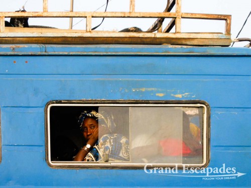 Lady patiently waiting for the bus to leave the Gare Routiere in Cap Skiring